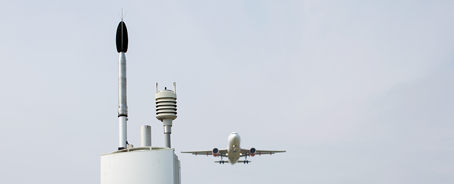 An aircraft flies over a noise monitoring terminal