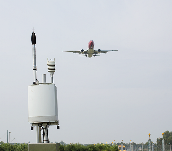 An aircraft overflies a noise monitoring terminal
